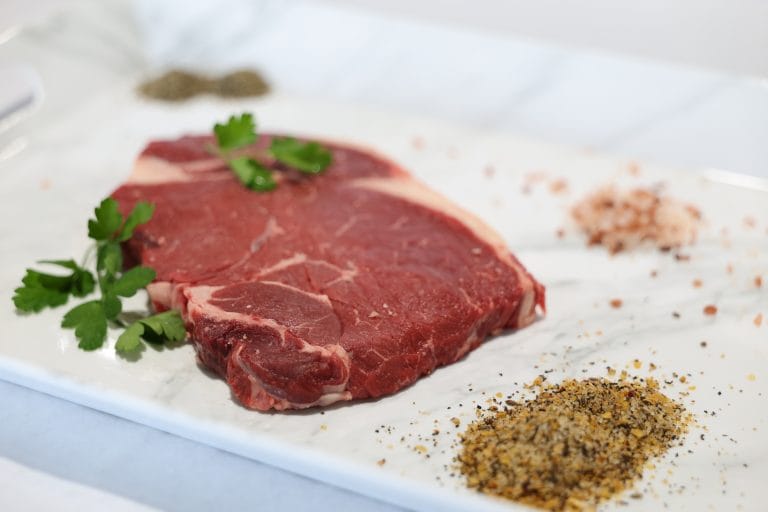 Raw steak by Jemstar Farms