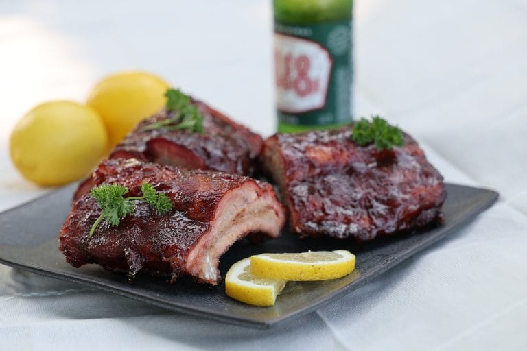 Three ribs on a platter, showcasing premium grilled ribs prepared by Silver Platter Foods